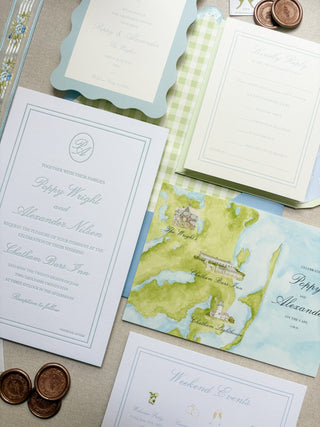 Wedding invitation set with watercolor map design for a Cape Cod coastal wedding on a textured surface