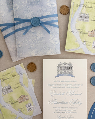 Vintage-style wedding invitations with blue ribbons and wax seals on a textured surface.