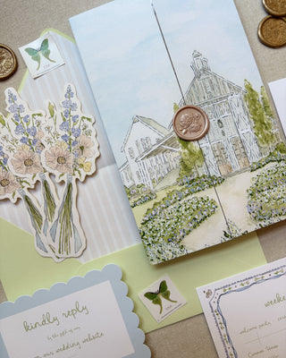 Wedding stationery set with watercolor floral design, venue illustration, and decorative elements on a textured surface